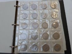 An amateur UK coin collection including coins with silver content, modern crowns etc, in an album
