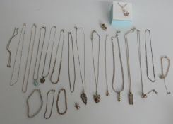 A collection of silver jewellery including earrings, chains, peridot pendant, ingot, emeralds etc