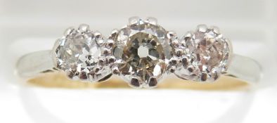 An 18ct gold ring set with three diamonds of approximately 0.25, 0.15 & 0.15ct in a platinum