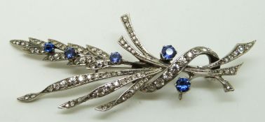 Silver brooch set with paste and sapphires in a floral design, 8 x 3.5cm