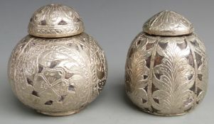 Two white metal overlaid lidded coconut jars with embossed detail, tallest 13.5cm
