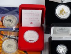 Five Australian silver coins comprising a proof centenary dollar, a 2002 1oz Lunar proof coin, a