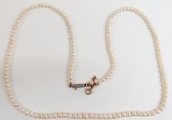 A single strand of natural pearls with diamond clasp, with Gem & Pearl Lab certificate
