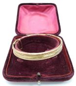 A 9ct rose gold bangle in original box, 8.9g