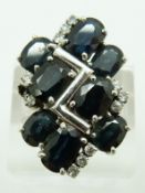 A white metal ring set with eight oval cut sapphires and diamonds, 10.1g, size U