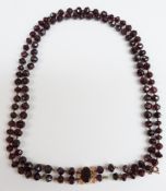 A two strand Victorian garnet necklace with a foiled garnet clasp