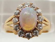 Edwardian 18ct gold ring set with an oval opal cabochon surrounded by diamonds, Birmingham 1901, 4.