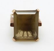 A 9ct gold ring set with a large emerald cut quartz, 11.2g, size M