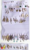 A collection of silver earrings including tiger's eye, quartz, turquoise, opal, and four silver