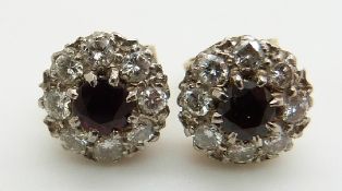 A pair of 9ct gold earrings set with garnets and diamonds