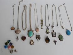 A collection of silver pendants including Art Nouveau style, jadeite style, amethyst etc