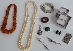 A collection of jewellery including pressed amber necklace, silver and marcasite pendant,