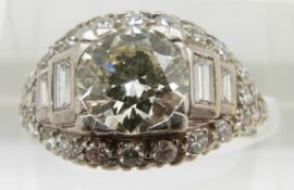 Art Deco ring set with a central diamond of approximately 1.5ct flanked by two baguette cut diamonds