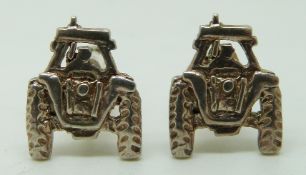 A pair of silver cufflinks in the form of tractors