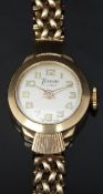 Timor 9ct gold ladies wristwatch with gold hands and Arabic numerals, silver dial and signed 17