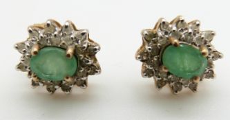 A pair of 9ct gold earrings each set with an emerald and diamonds