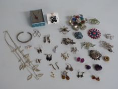 A collection of silver earrings including pressed amber, labradorite, garnet, a white metal