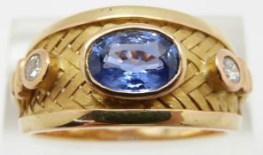 An 18ct bespoke gold basket weave ring set with an oval cut natural untreated cornflower blue