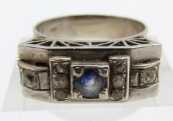 Art Deco white metal ring set with a round cut cornflower blue sapphire and old cut diamonds by