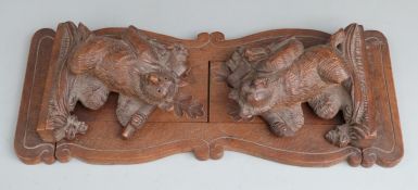 Black Forest carved wood bookslide with bear carrying wood and an axe, minimum length 35cm