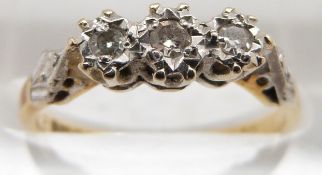 An 18ct gold ring set with three diamonds in a platinum setting, 2.7g, size L