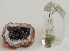 A quartz crystal containing a mineral inclusion and a geode.
