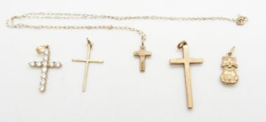 Three 9ct gold cross pendants, two 9ct gold chains (5g) and a 14k gold cross pendant set with