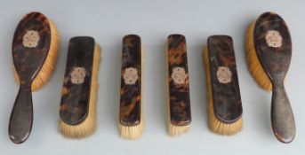 Tortoiseshell six piece dressing table set with yellow metal mounts formed as initials