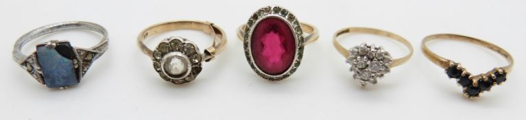 A 9ct gold ring set with sapphires, three 9ct gold rings, and a silver ring