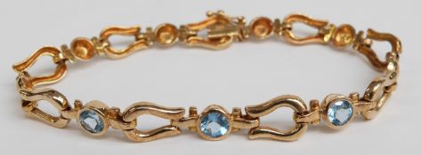 A 14ct gold bracelet set with round cut blue topaz,12.3g