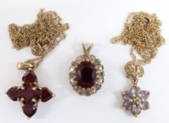 A 9ct gold pendant set with garnets, 9ct gold pendant set with topaz and 9ct gold pendant set with