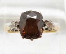 An 18ct gold ring set with a cushion cut smoky quartz and two diamonds, 4g, size P