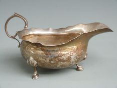 Edward VII hallmarked silver sauce boat with shaped edge, pad feet and scroll handle, Chester 1907