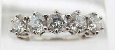 An 18ct white gold ring set with five round brilliant cut diamonds, total diamond weight 1.5ct,