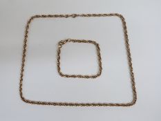 A 9ct gold spiral link necklace and matching bracelet, drop of necklace 25cm, 27.4g
