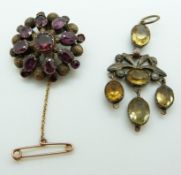 AVictorian brooch set with foiled garnets over textured sections and a Victorian/ Georgian pendant