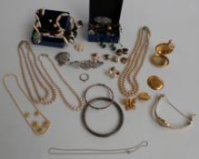 A collection of jewellery including a hallmarked silver flapper bangle, silver and marcasite brooch,