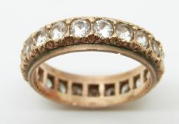A rose gold eternity ring set with white sapphires, 4g, size O