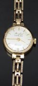 Bruford of Eastbourne 9ct gold ladies wristwatch with gold hands and baton markers, silver dial