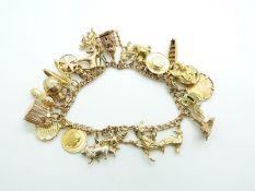 A 9ct gold charm bracelet, with an 18ct gold charm, 9ct gold monkey, donkey, octopus, elephant set