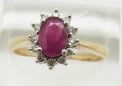 A 9ct gold ring set with a ruby surrounded by diamonds, 3.2g, size S