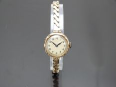 Buren 9ct gold ladies wristwatch with blued hands, black Arabic numerals, champagne dial and