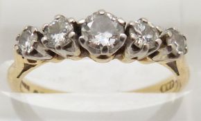 An 18ct gold ring set with five round cut diamonds, 3.1g, size L