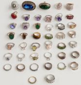 A collection of silver rings set with tiger's eye, quartz, amethyst, garnet, paste, peridot etc