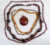Two beaded amber necklaces, one with yellow metal clasp together with a white metal mounted amber