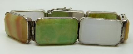 A silver bracelet set with sections of hardstone