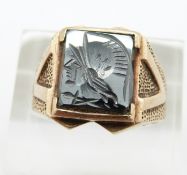 A 9ct gold ring set with a carved hematite intaglio, 5.8g, size P