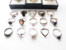 A collection of silver rings including pearl set, cameo, peridot, quartz etc