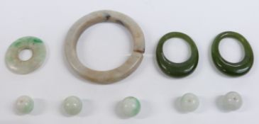 Two nephrite jade rings, jade discs, and jade beads