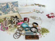 A collection of costume jewellery to include brooches, beads, hat pins, paste jewellery, silver